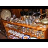 A generous selection of metal ware including copper, brass, pewter and silver - on two shelves