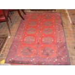 A Middle Eastern rug with red ground and geometric