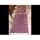 A Middle Eastern rug with red ground - 154cm x 90c