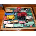 A collection of antique diecast model cars and vehicles - mostly Dinky - with wall display case