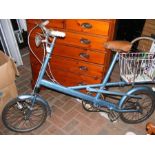 A vintage lady's bike with basket on back