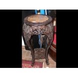 A Victorian carved Chinese two tier plant stand -