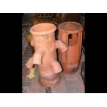 A terracotta chimney pot, together with another