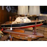 A model fishing boat on stand