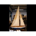 An old wooden pond yacht with sails on stand - 108cm long