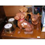 A number of carved wooden dogs, together with othe