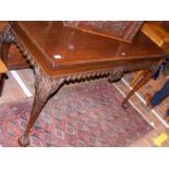 An Irish style mahogany serving table with carved