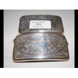 A silver card case with engraved decoration and on