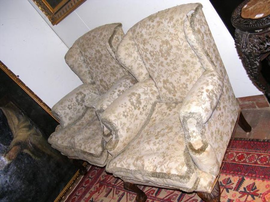 A pair of antique wing easy chairs with carved cab