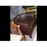 A brown leather style tub chair