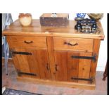 A pine sideboard with drawers and cupboards below