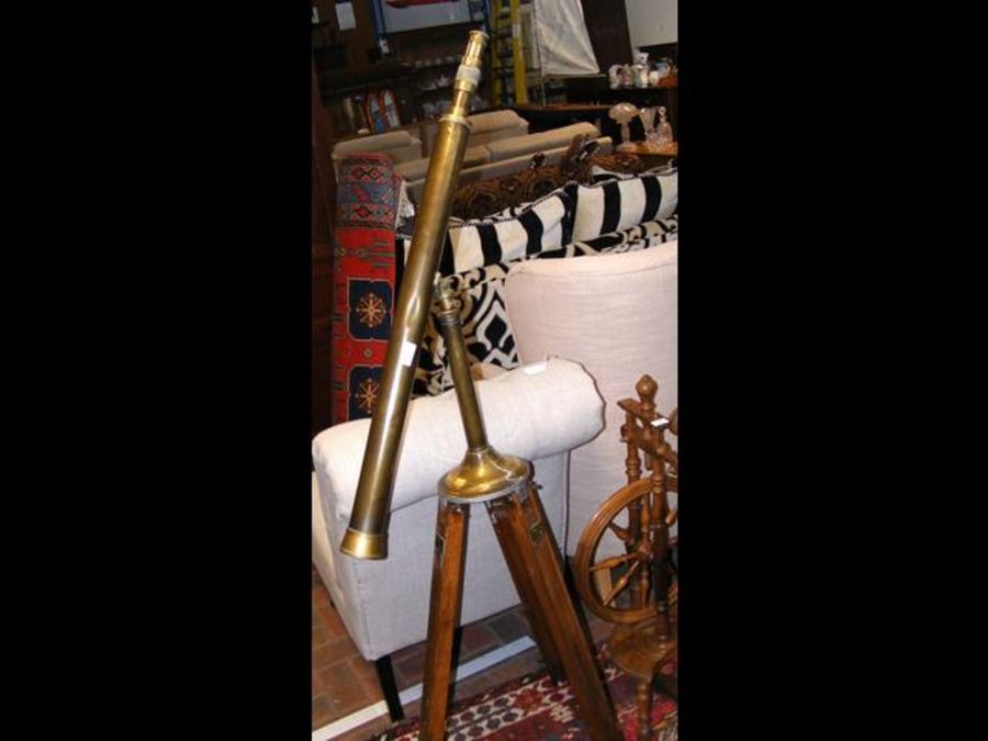 A brass telescope on adjustable wooden stand