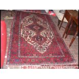 A Middle Eastern style carpet with geometric borde