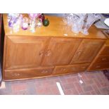 An Ercol Golden Dawn sideboard with drawers and cu