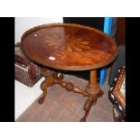 An oval antique occasional table with stretcher ba