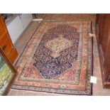 An antique Persian Sirjan rug - 200cm x 125cm