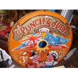 An old circular Punch & Judy sign 'Welcome to Br