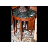 A circular burr walnut occasional table with a green marble top