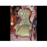 A Victorian armchair with button back and cabriole