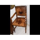 An antique armchair with leather seat and backrest