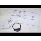 A three stone tanzanite ring in platinum setting,