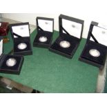 A selection of five collectable boxed coins