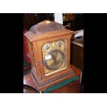 An oak cased chiming mantel clock - 42cms high