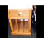 A hardwood cabinet with drawer and compartment und