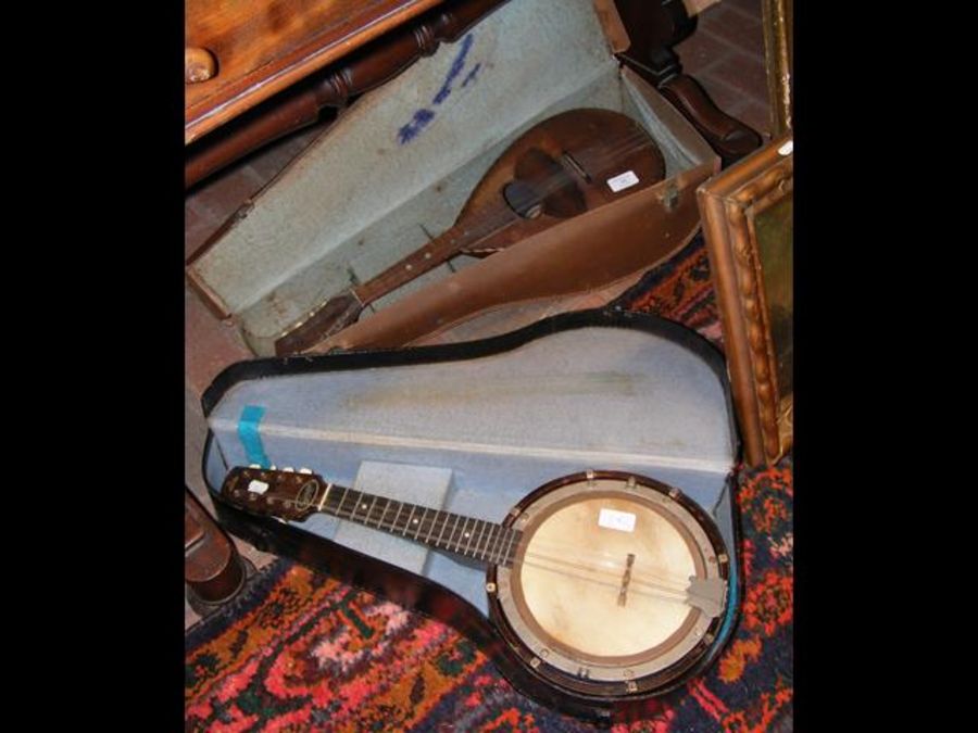 A cased mandolin together with a cased banjo