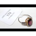 A gold ring set with facetted garnet and diamond s