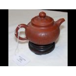 A Chinese globular teapot with calligraphy decorat