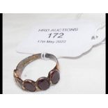 A 9ct gold antique ring set with five 'garnets' in