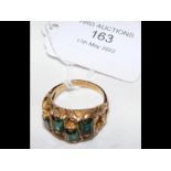 A 14ct gold ring set with four emeralds