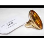 A gold ring with elliptical amber