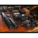 A quantity of vintage cameras and other optical eq