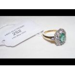 An 18ct yellow and white gold emerald and diamond