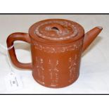 A Chinese redware teapot with calligraphy decorati