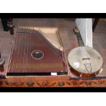 An old zither together with a banjo made by John G