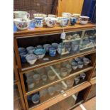 A medley of teacups - on four shelves