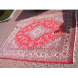 A Middle Eastern bordered carpet with floral desig