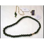 A jade necklace, jade ring and a jade 'fish' neckl