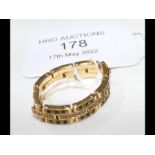 A gold 'bracelet' ring set with diamonds and emera