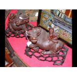 A pair of old carved oriental Buffalo on wooden st