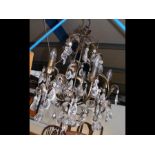 A metal candelabra style ceiling light with glass