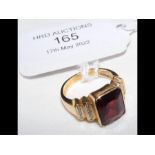 A 14ct gold ring with central garnet