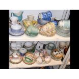 A medley of cups and saucers - on two shelves