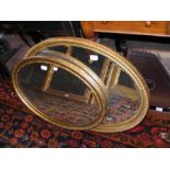 An oval gilt framed wall mirror and one other
