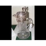 A cut glass and silver plated claret jug with 'lio