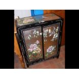 A Chinese style lacquered side cabinet with bird a