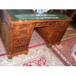 A reproduction pedestal desk with nine drawers to